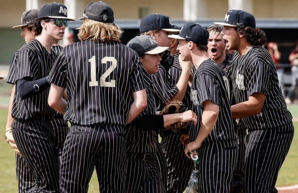 Baseball team huddled together on the field during a game